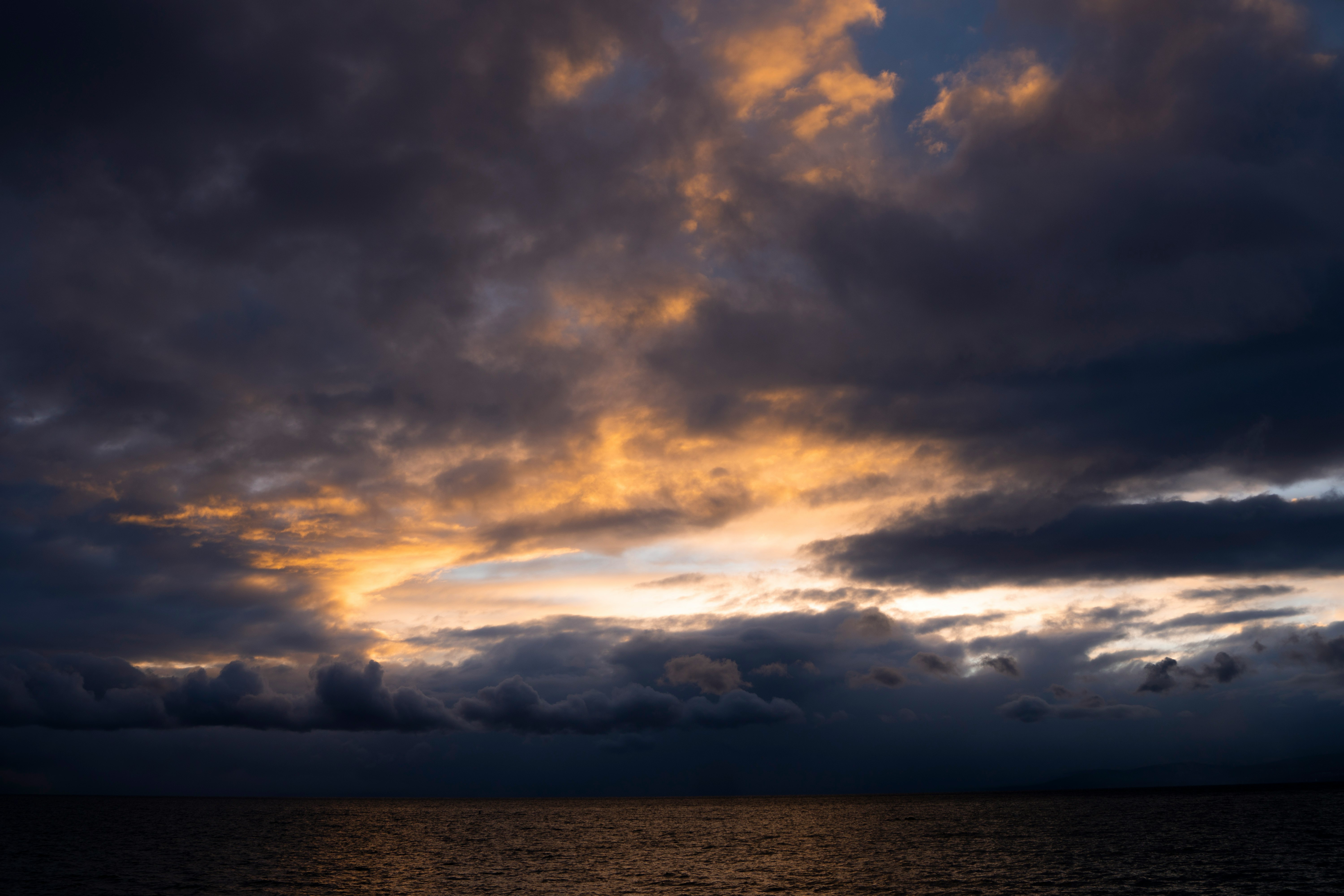 body of water under cloudy sky during daytime